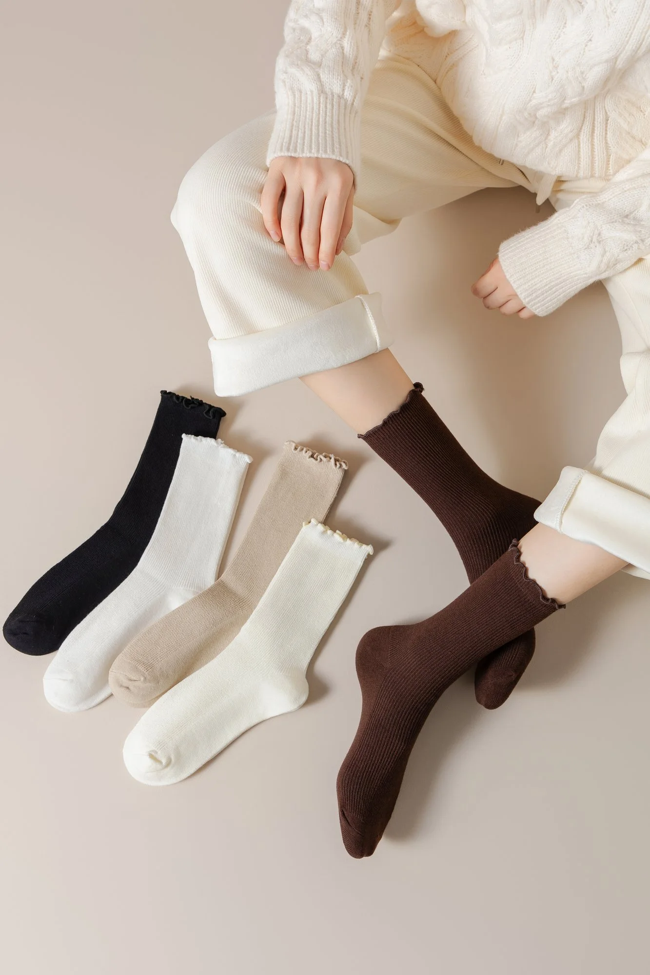 Women’s ruffle-edge slouch crew socks worn on both feet, shown with the five solid colors laid out beside them.